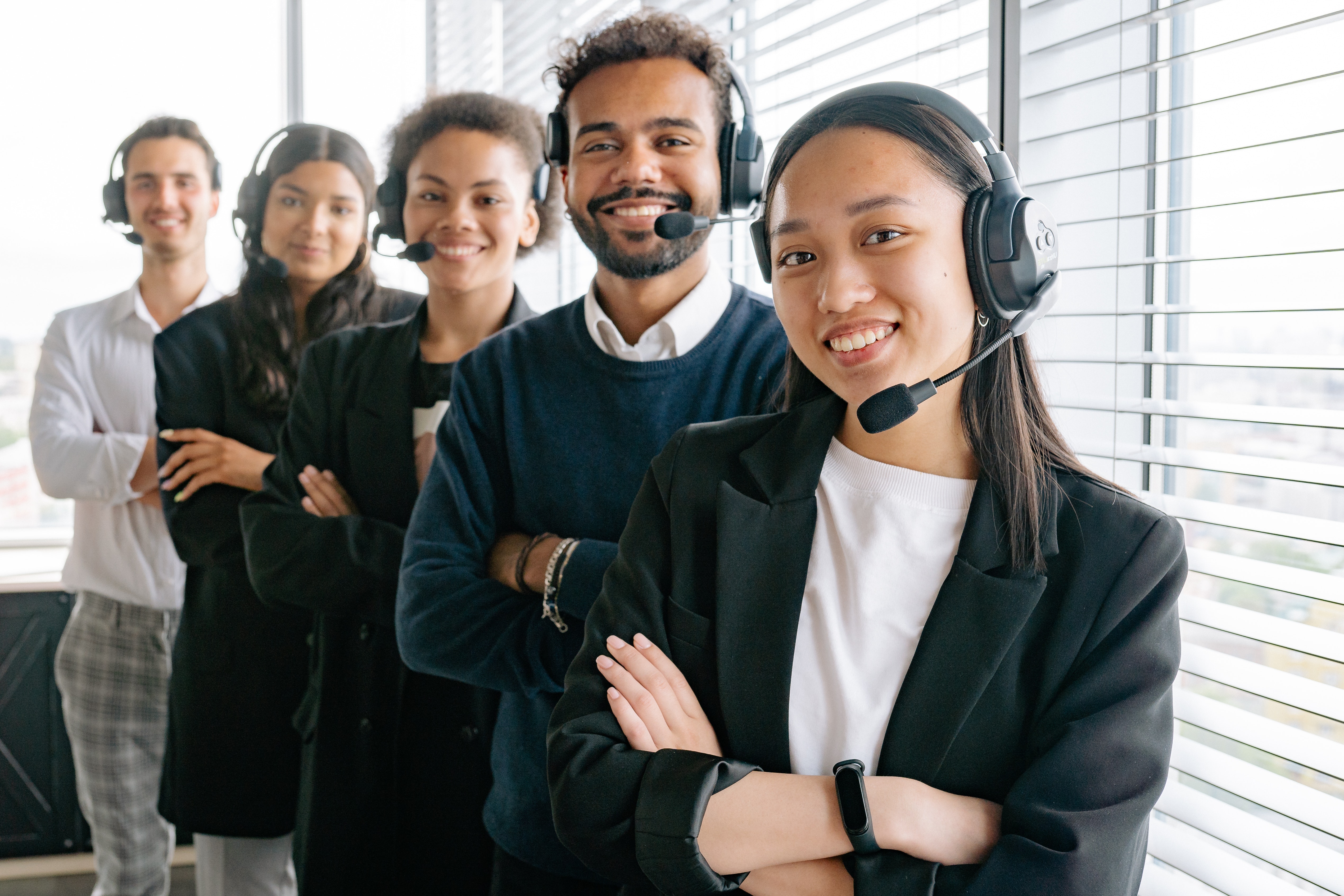 An image of people standing in a line with headsets on.